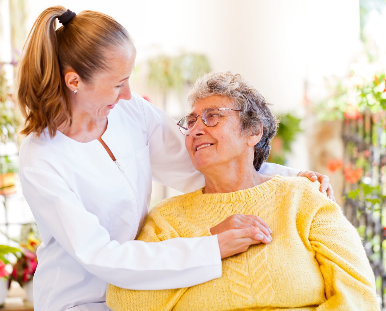 Healthcare worker interacting with a senior resident.