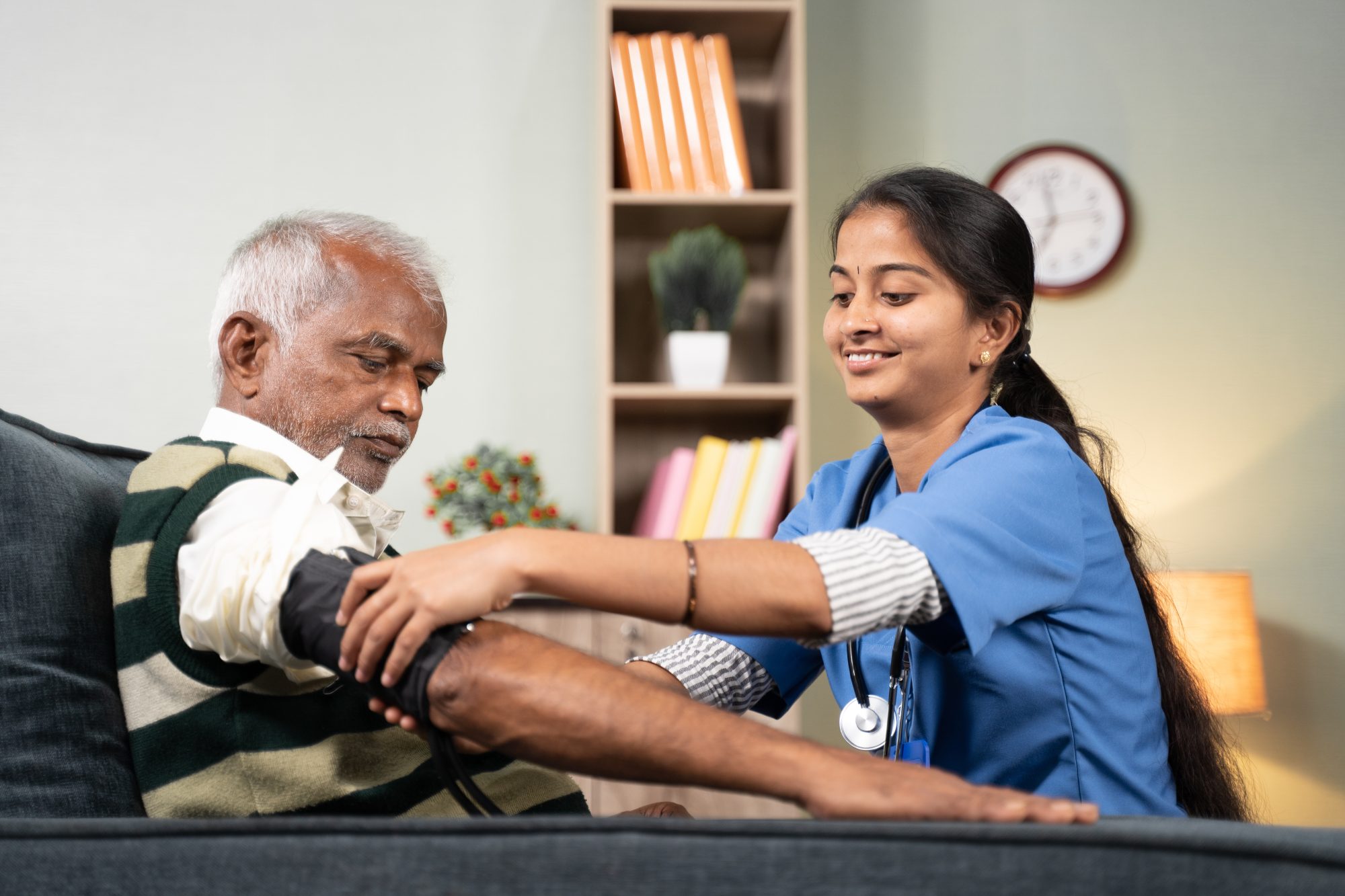Nurse taking blood pressure of an elderly man