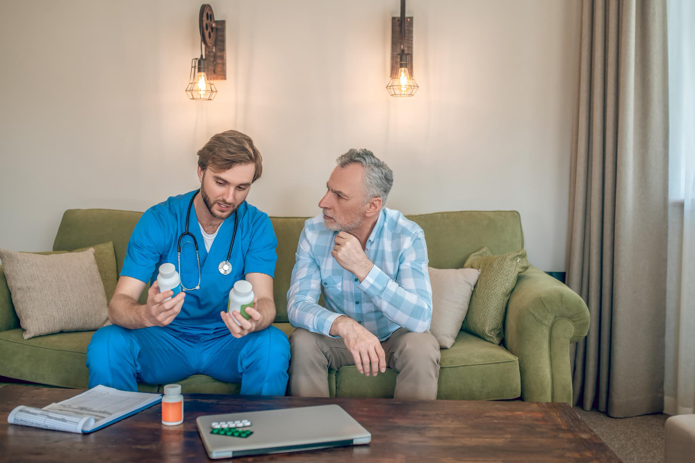 Nurse explaining medications to a senior resident