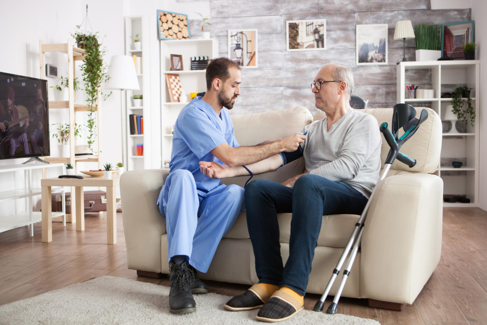 Healthcare professional assisting an elderly man at home