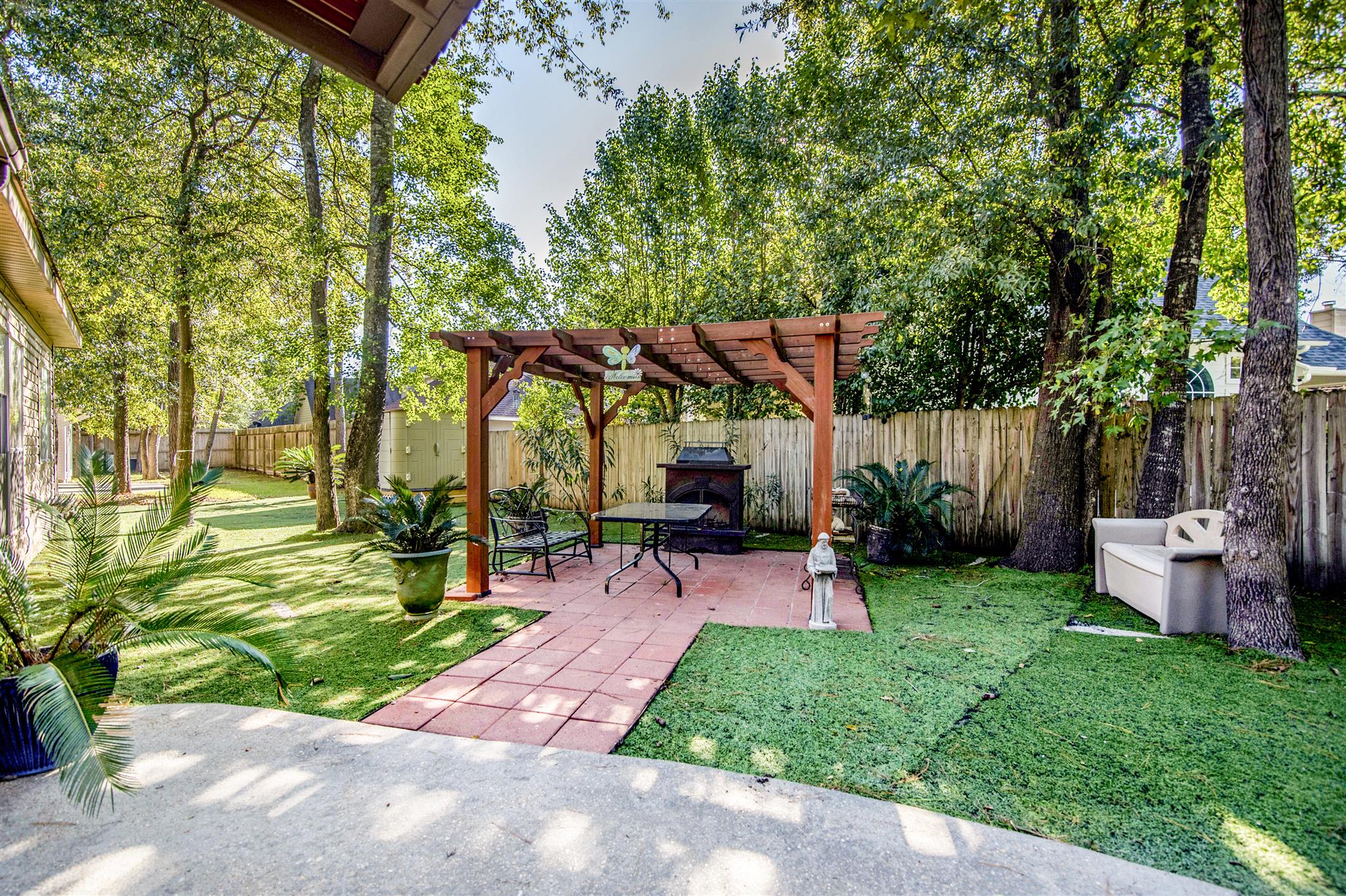Outdoor seating area with a pergola and greenery