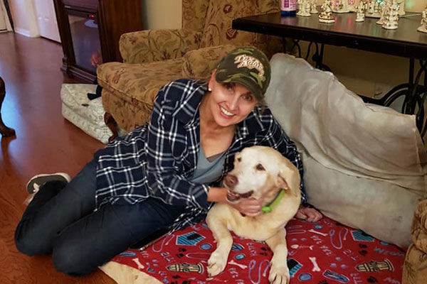 Resident enjoying time with a dog in a cozy room
