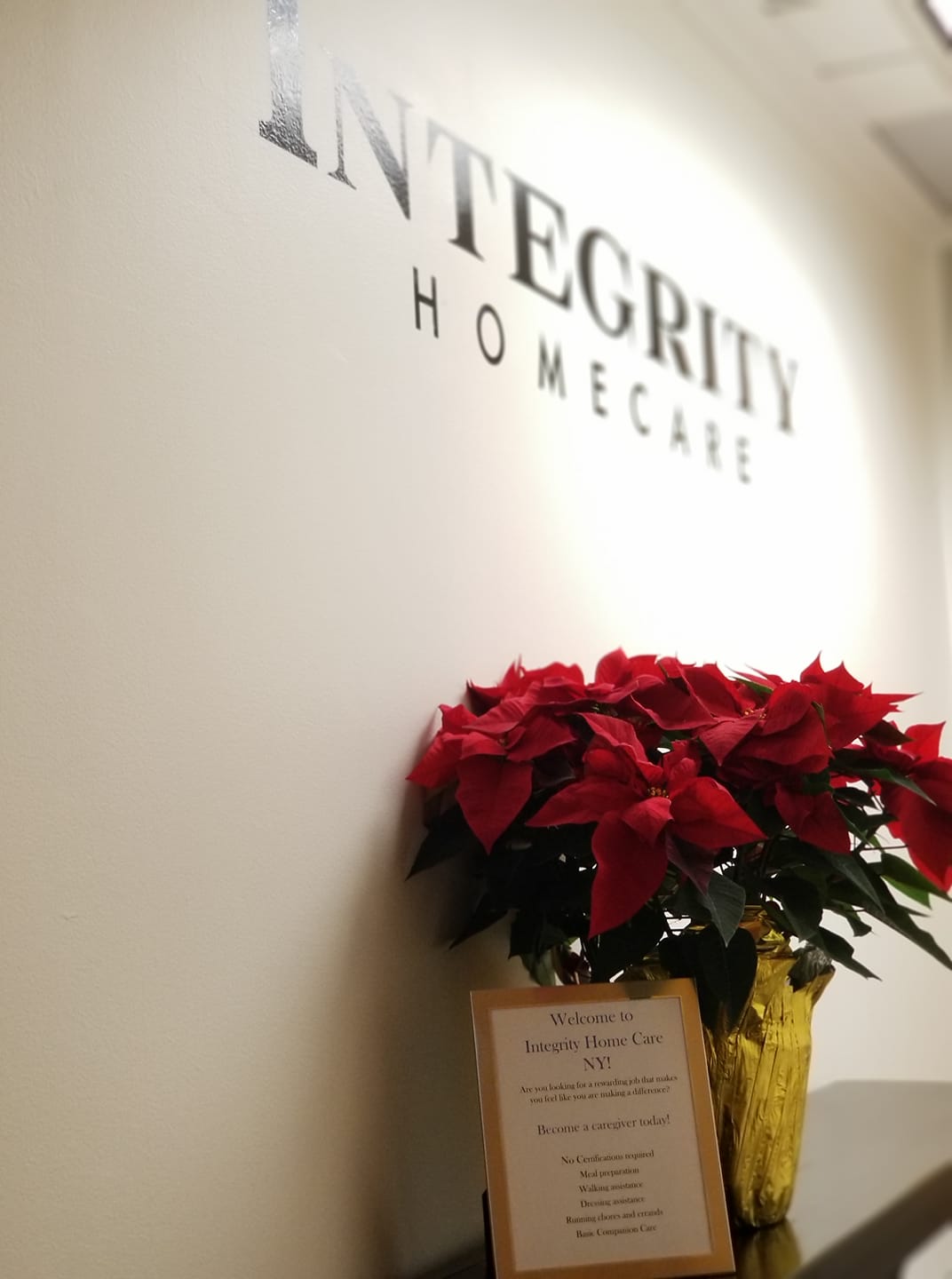 Interior photo of facility lobby with plants and welcome sign