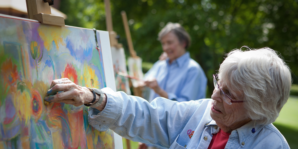 Residents painting outdoors during an activity.