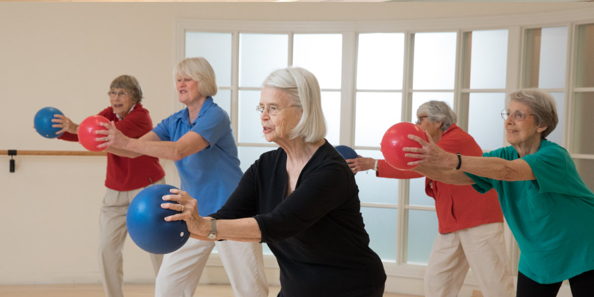 Residents engaging in a group exercise activity indoors.