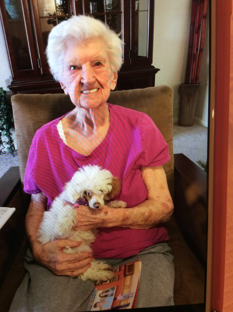 Elderly woman holding a small dog