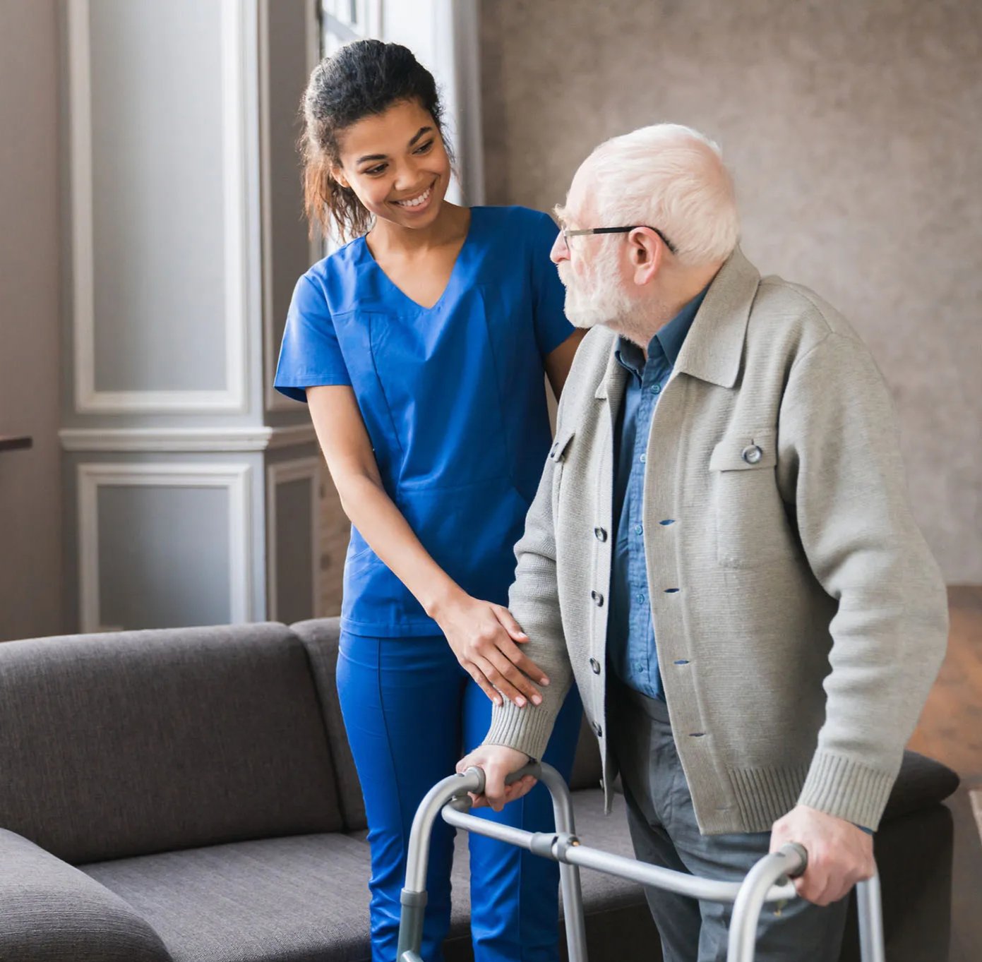 Nurse assisting an elderly man with a walker