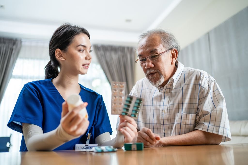Nurse discussing medication with an older man
