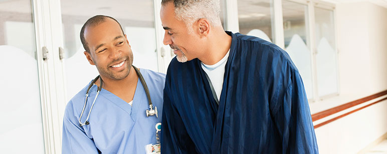 Caregiver assisting a resident in a hallway