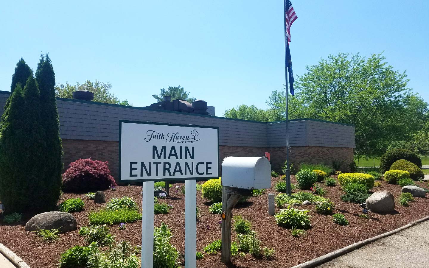 Exterior view of facility main entrance with landscaping