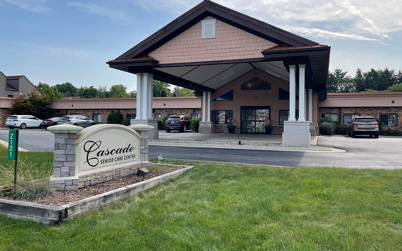Entrance of a senior care facility with landscaped area.