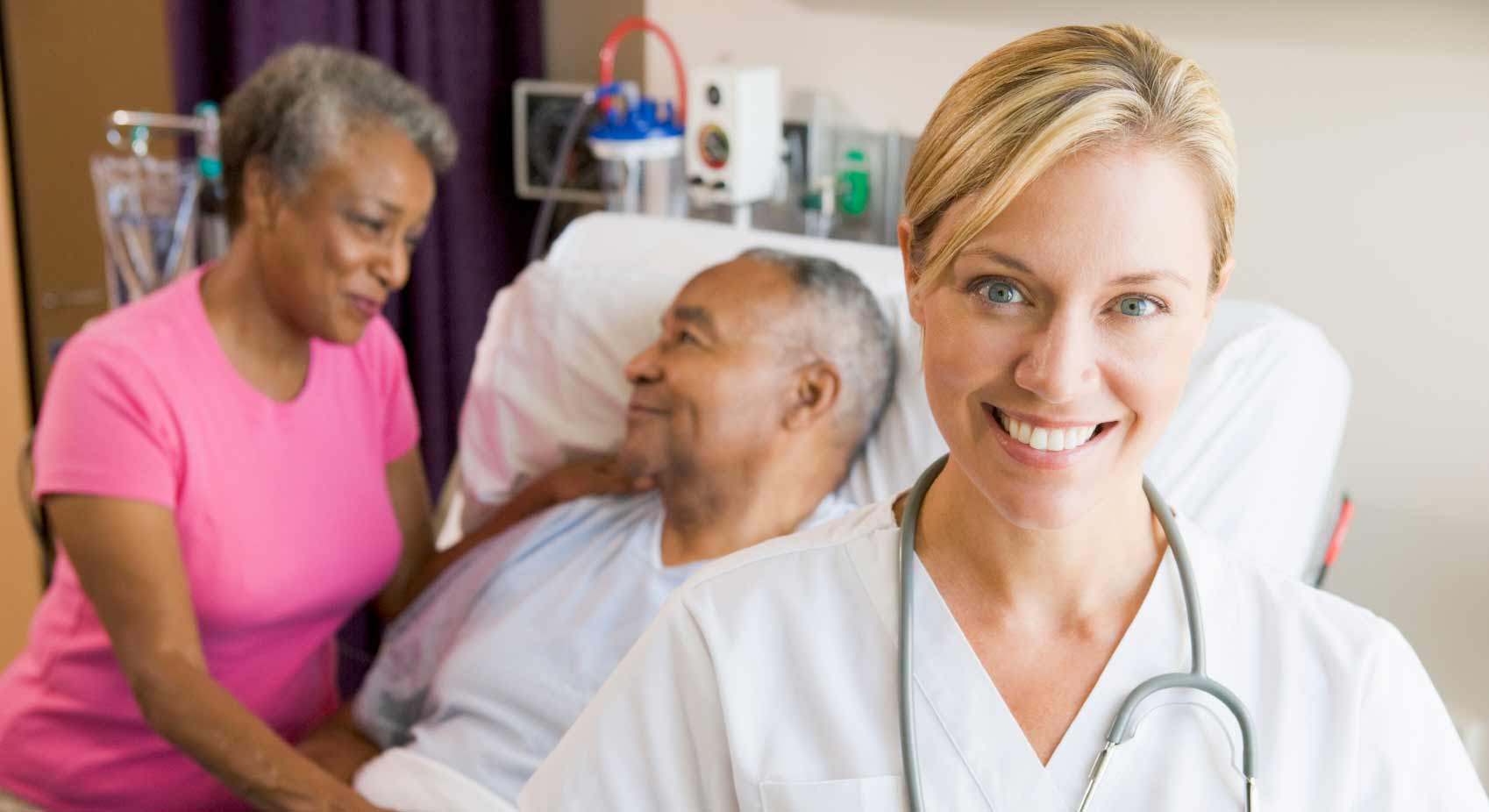 Smiling nurse with residents in a care setting.