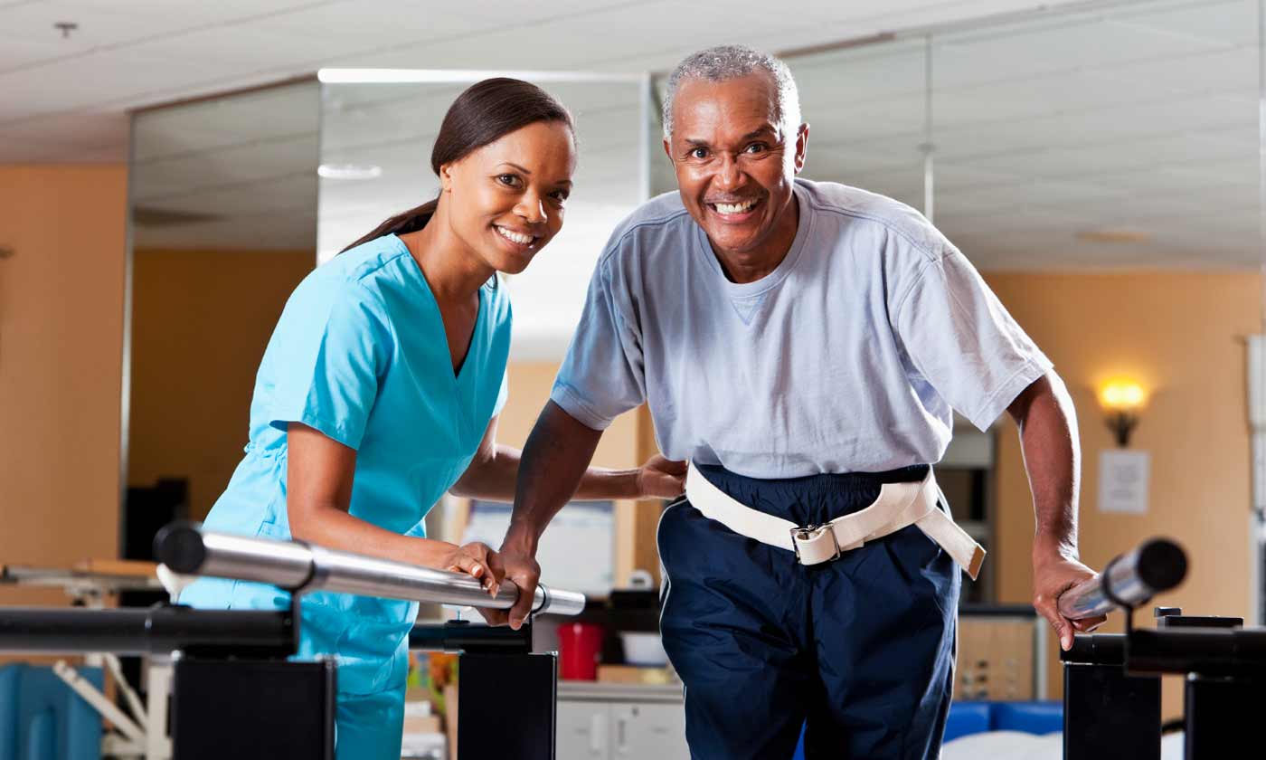 Health professional assisting senior in therapy