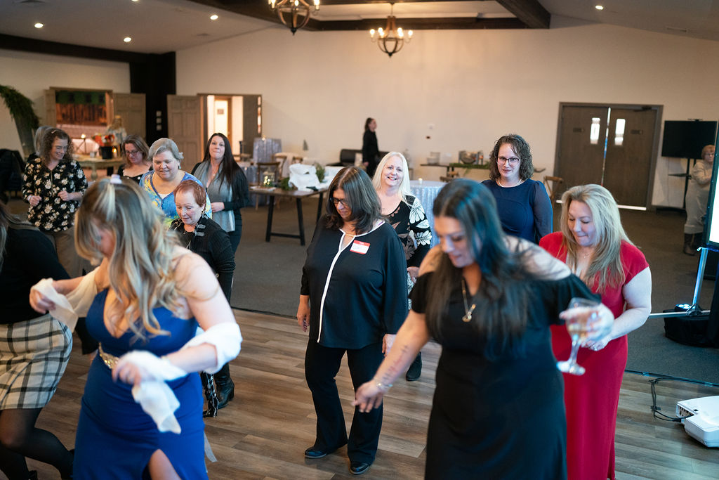 Residents dancing in a festive indoor event