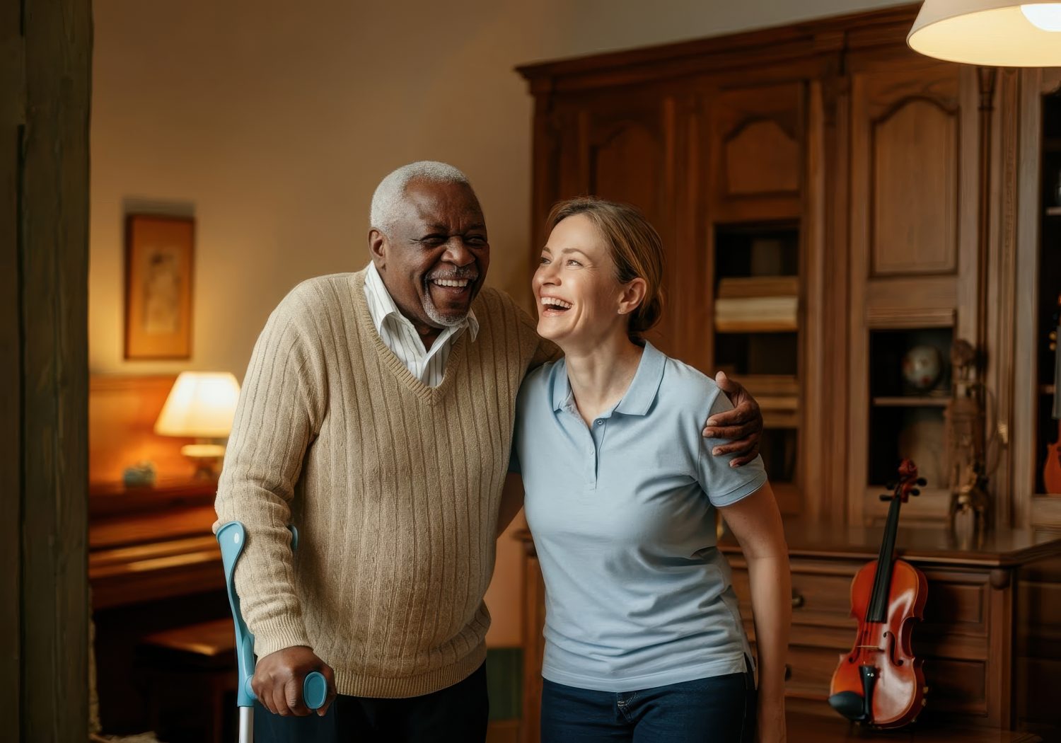 A resident and staff member smiling in a cozy interior