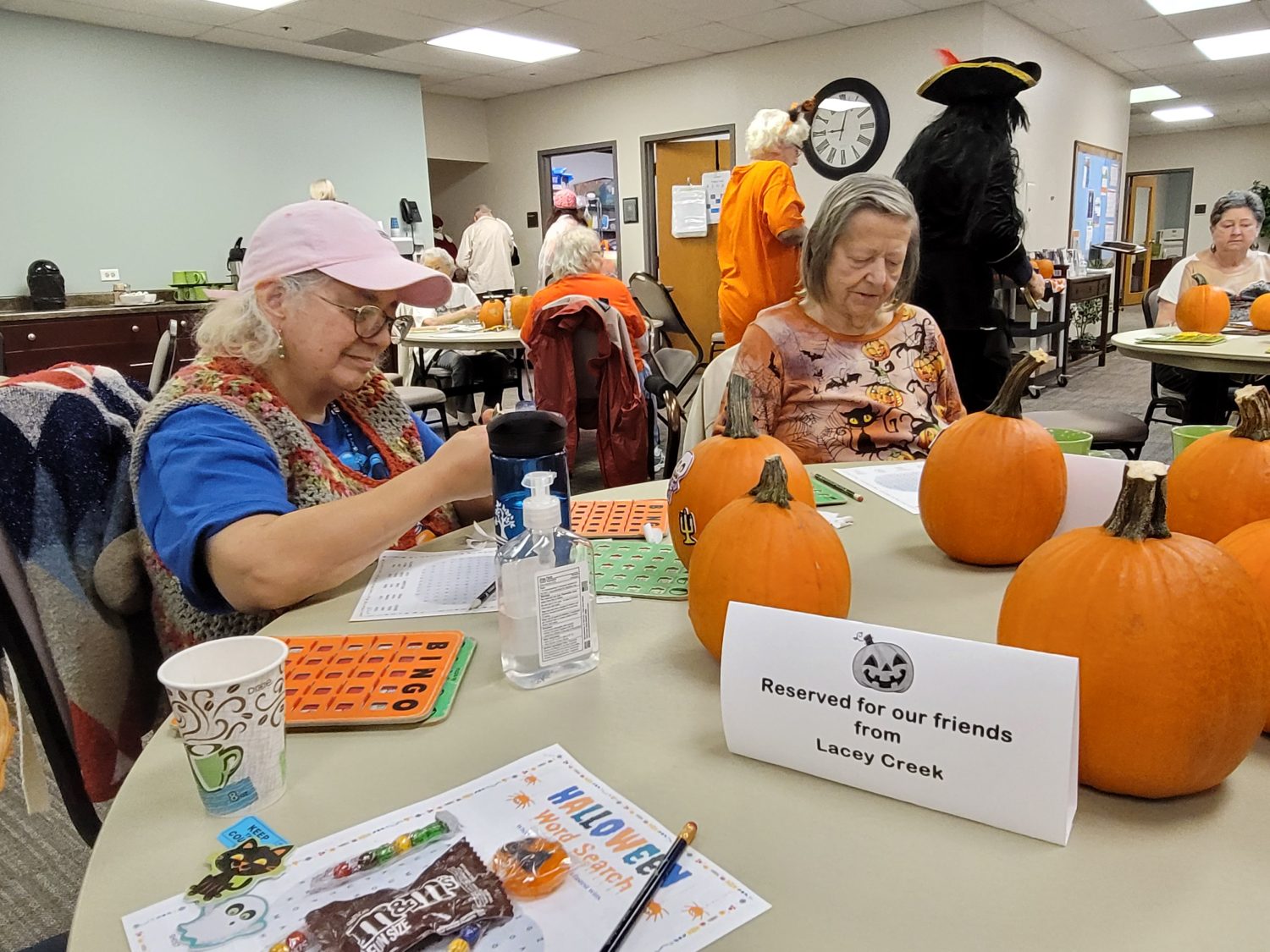 Residents enjoying a festive activity with pumpkins