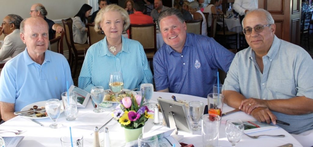 Group of four people dining at a table.