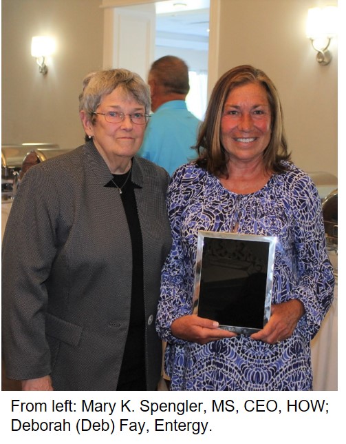Two women at an event holding an award