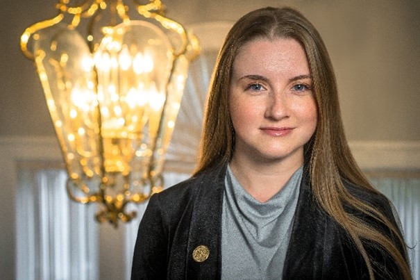 Portrait of a staff member in a well-lit interior space.
