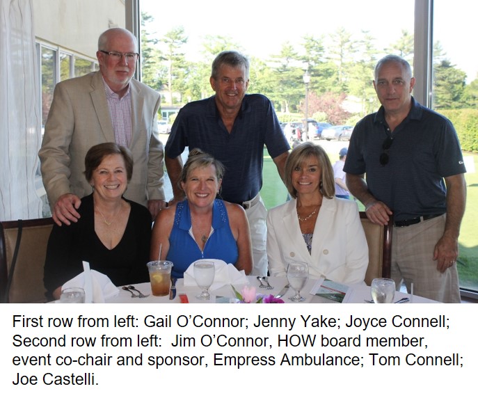 Group of six people at a dining table celebrating an event.