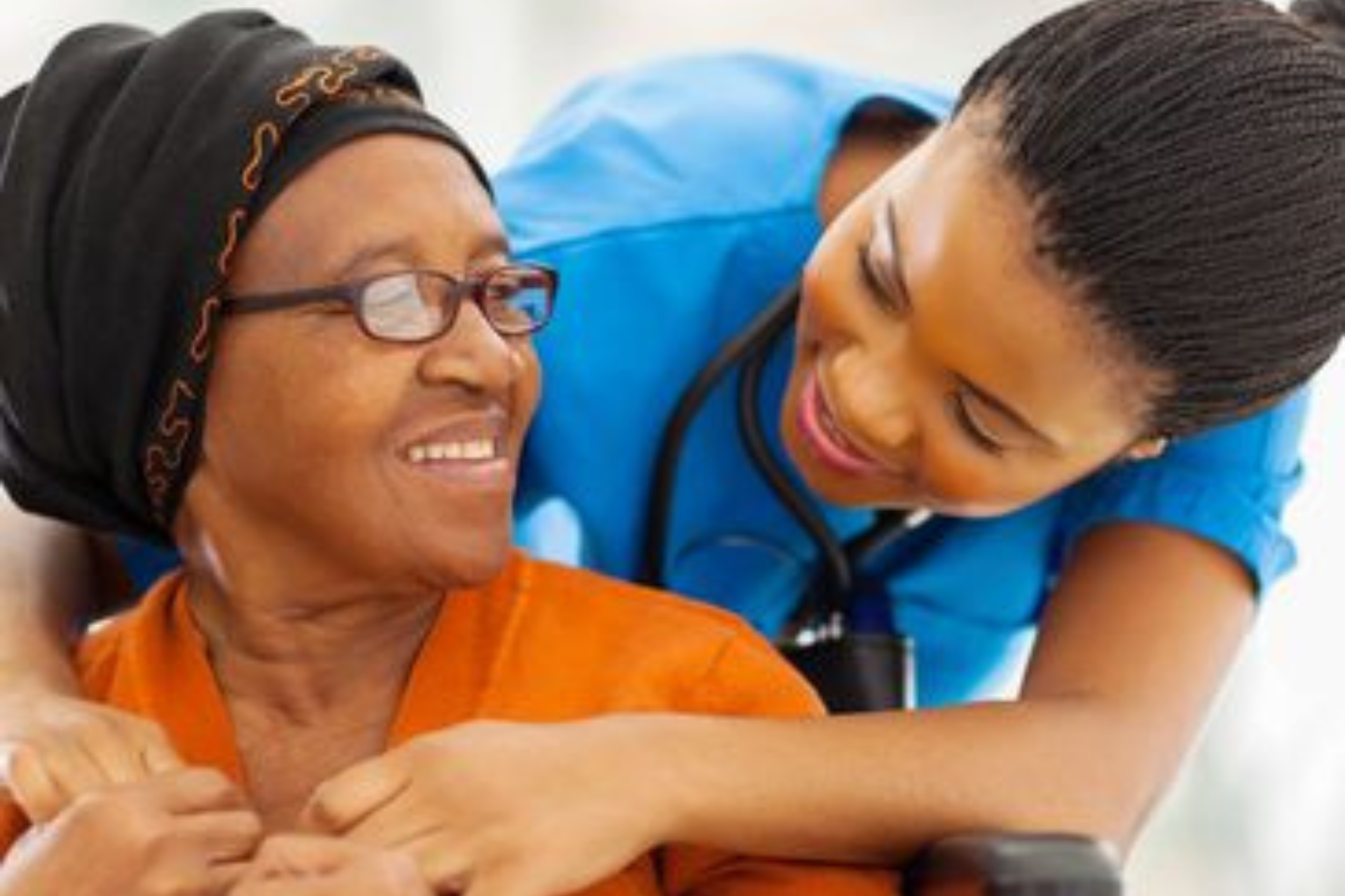 Caregiver interacting with a smiling resident.