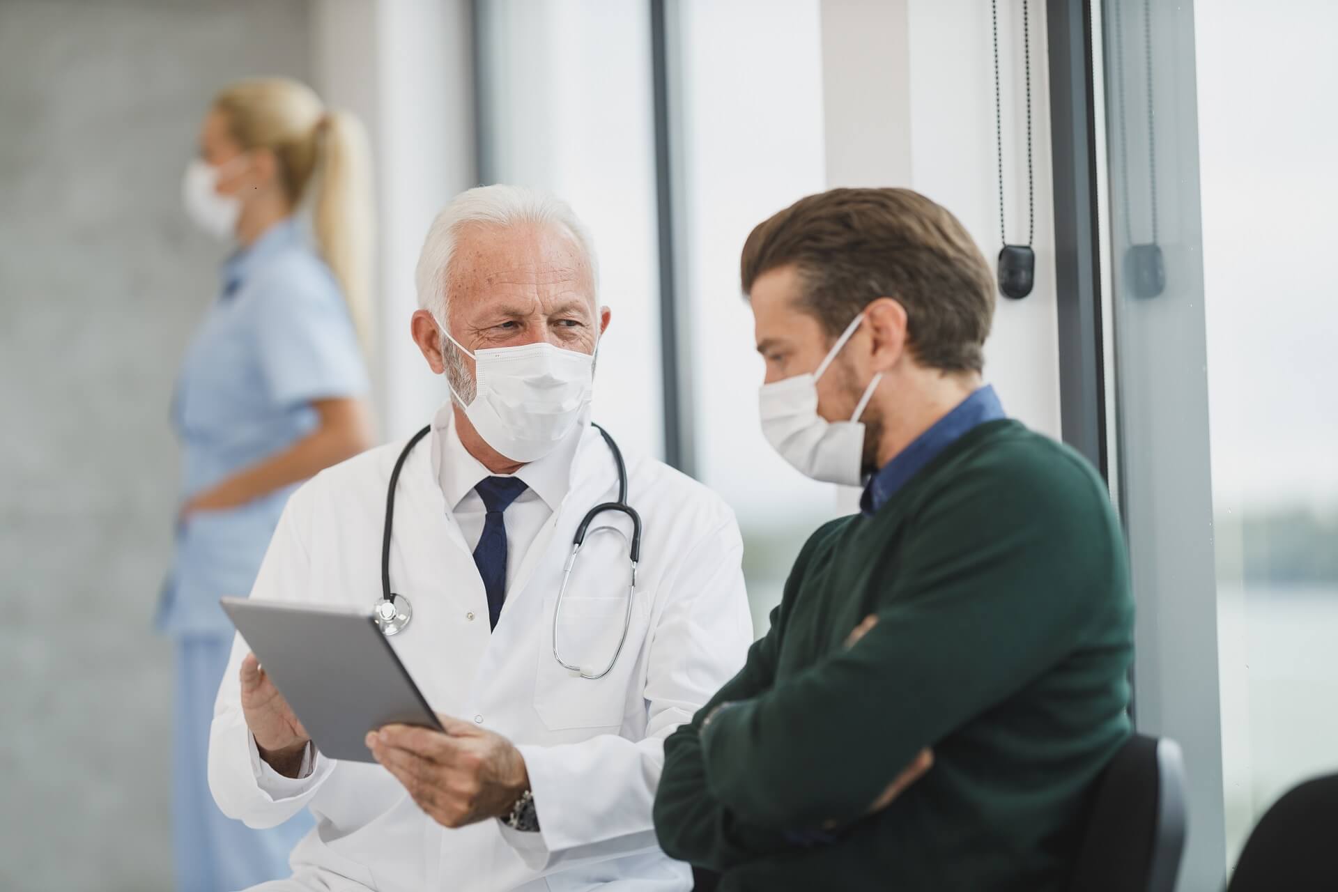 Doctor and patient discussing on a tablet