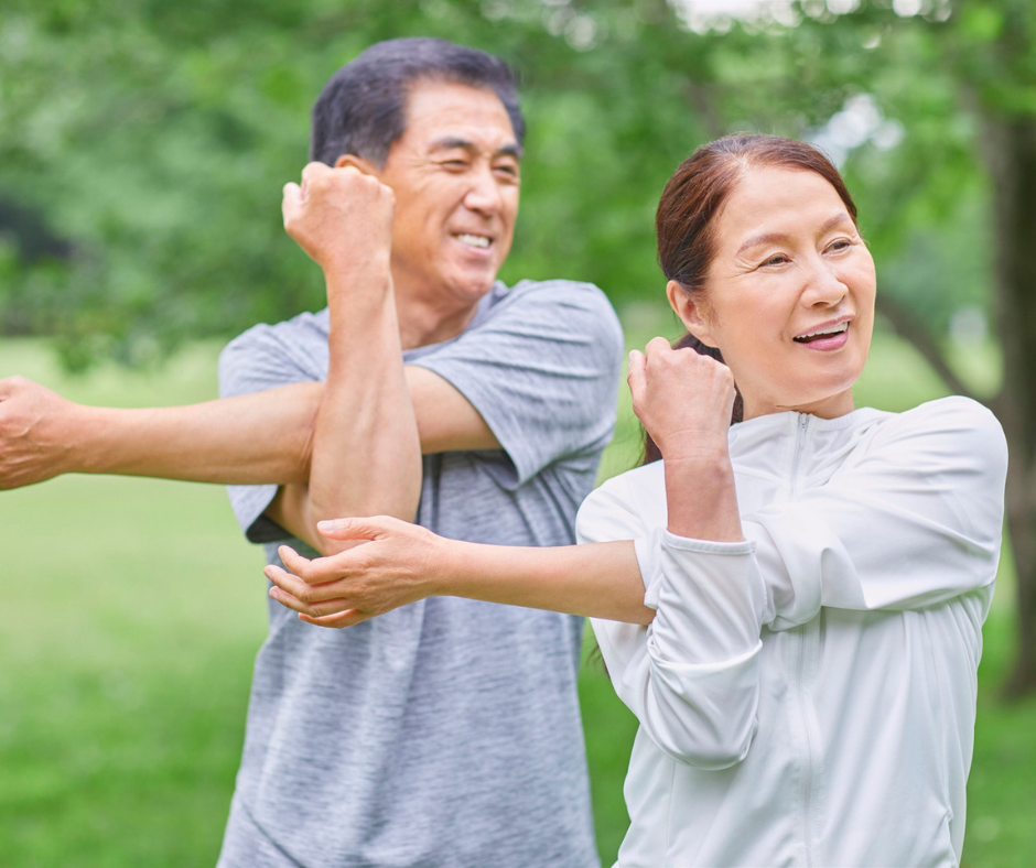 Senior adults engaging in outdoor stretching exercise