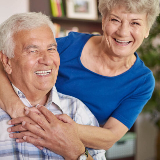 Smiling elderly couple in a cozy interior
