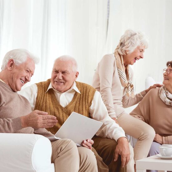 Seniors enjoying conversation in a common area