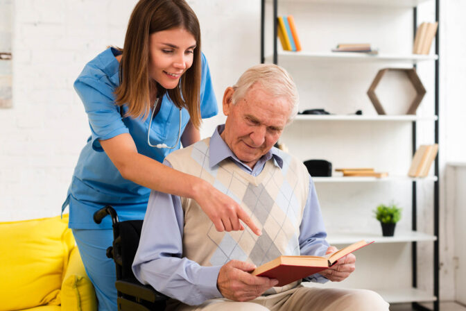 Caregiver assisting a resident with a book