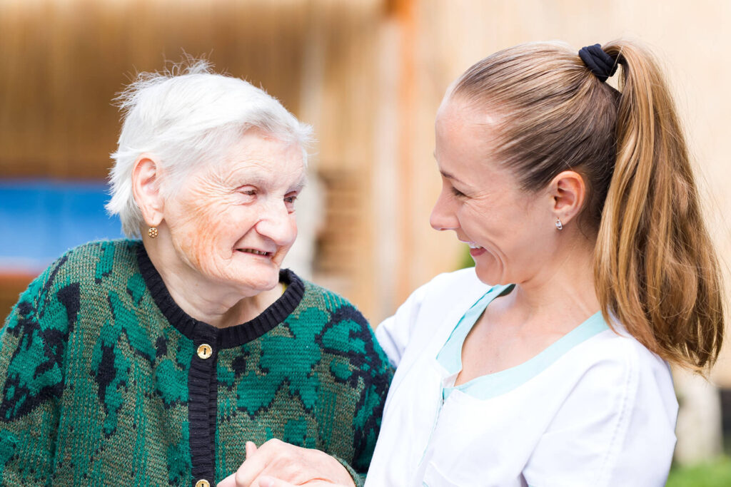 Senior woman enjoying conversation with caregiver