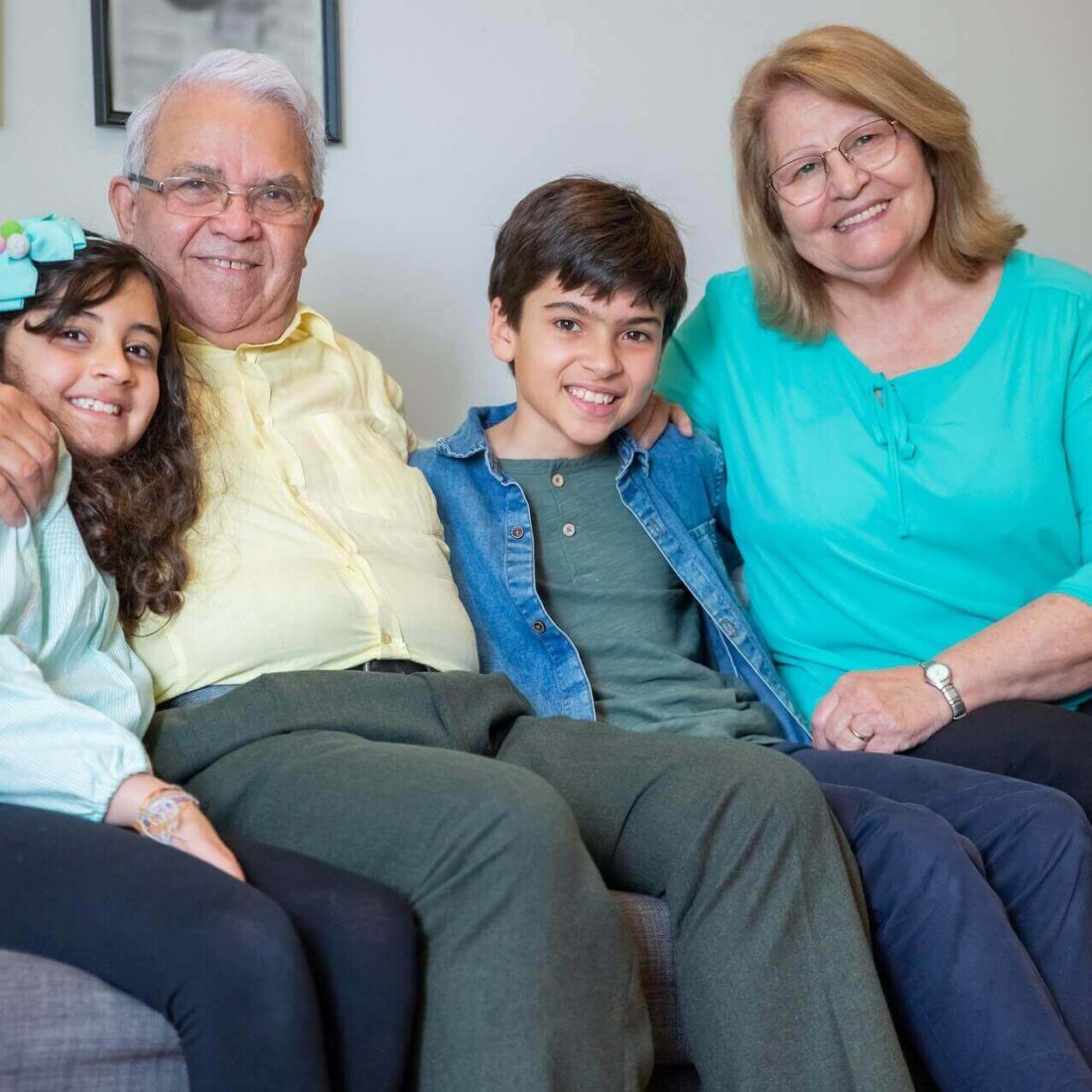 Family (two grandparents and two children) smiling together