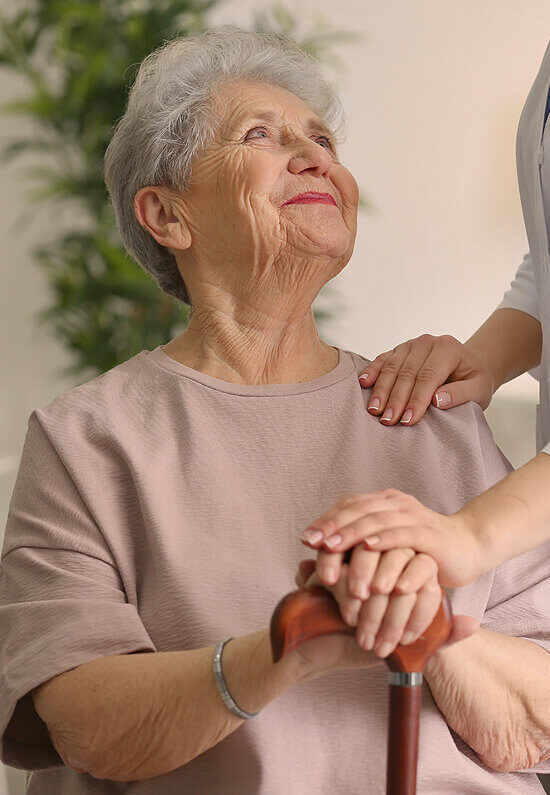 Elderly woman in a supportive environment with caregiver