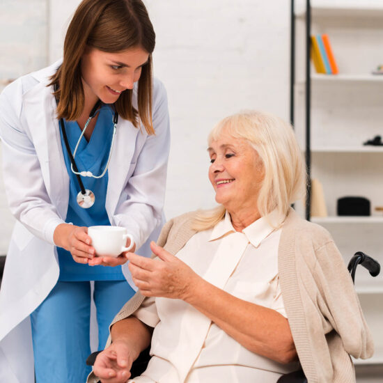 Healthcare worker assisting a senior woman
