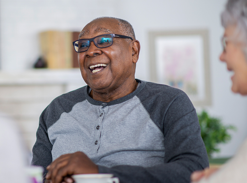 Smiling senior man enjoying time with friends.