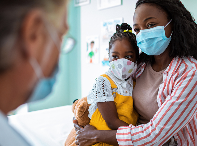 Mother and child interacting with a healthcare professional
