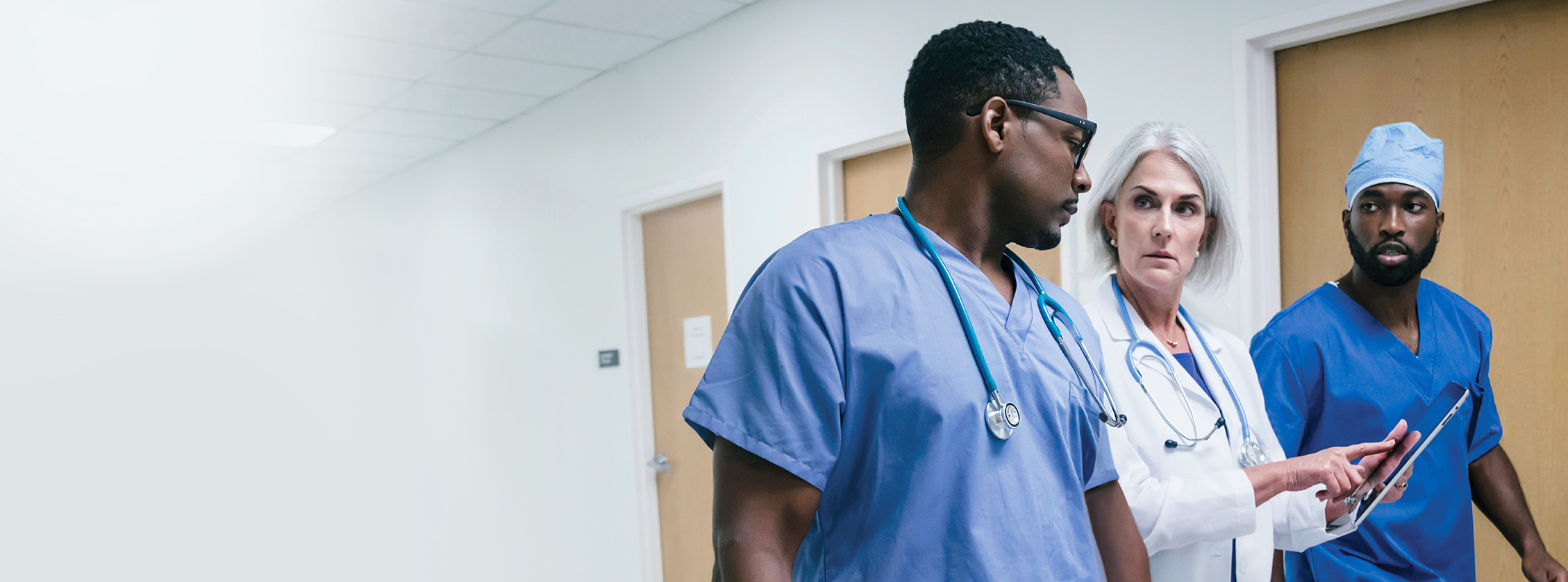 Healthcare professionals discussing in a hallway