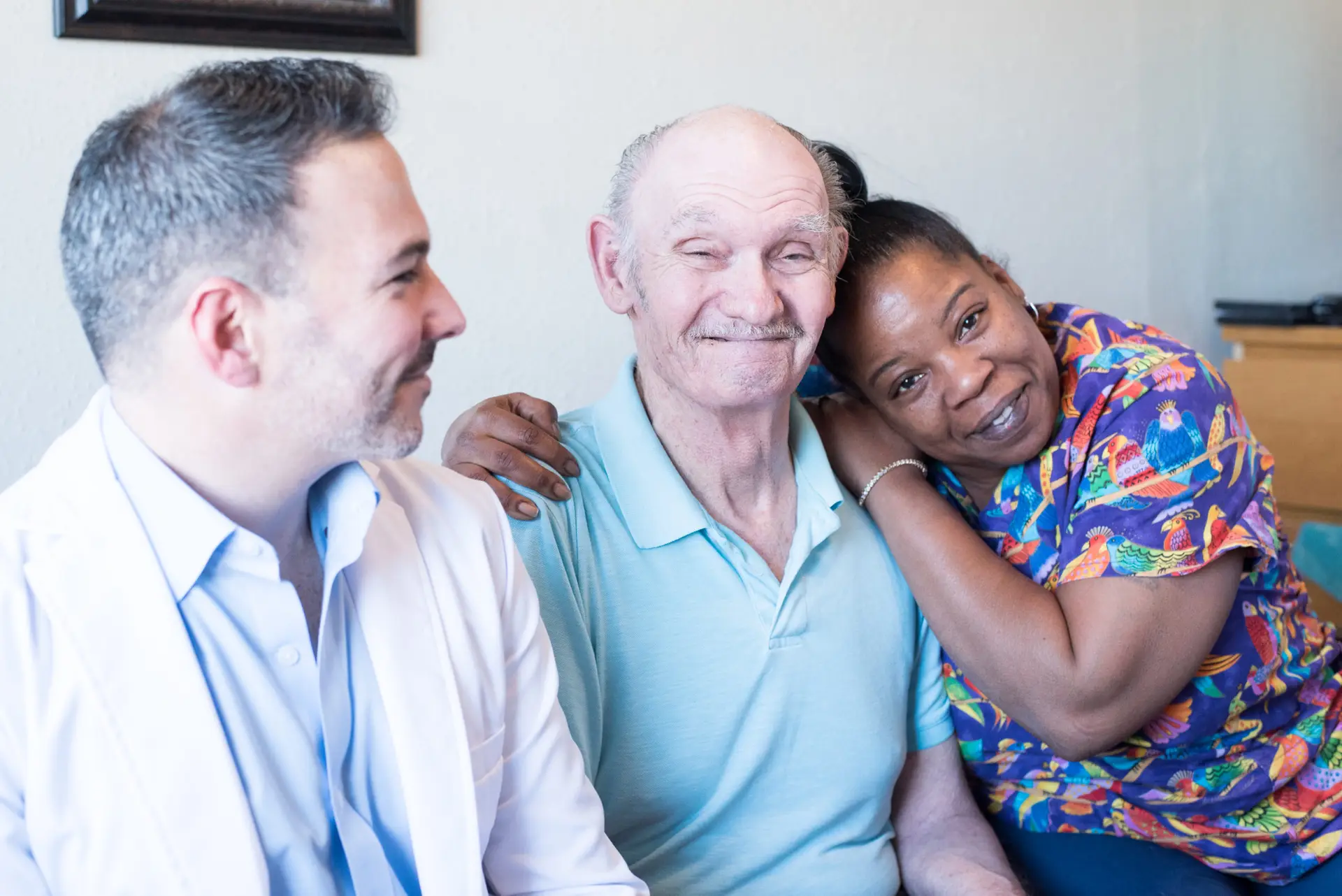 Care staff and a resident share a joyful moment.