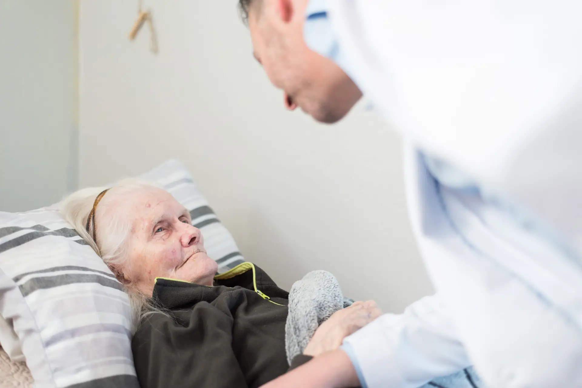 A caregiver interacting with an elderly resident.