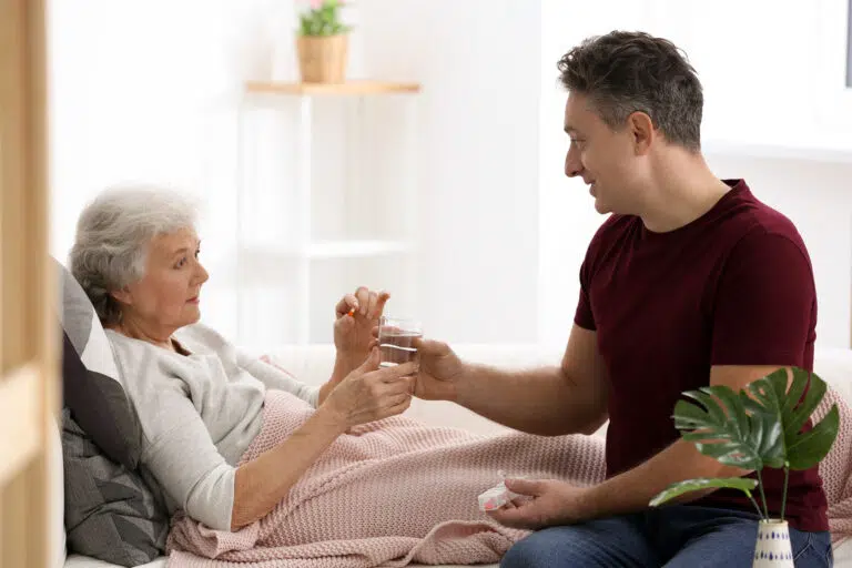 Caregiver providing assistance to an elderly woman