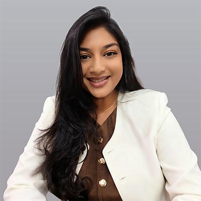 Smiling woman in a professional outfit.