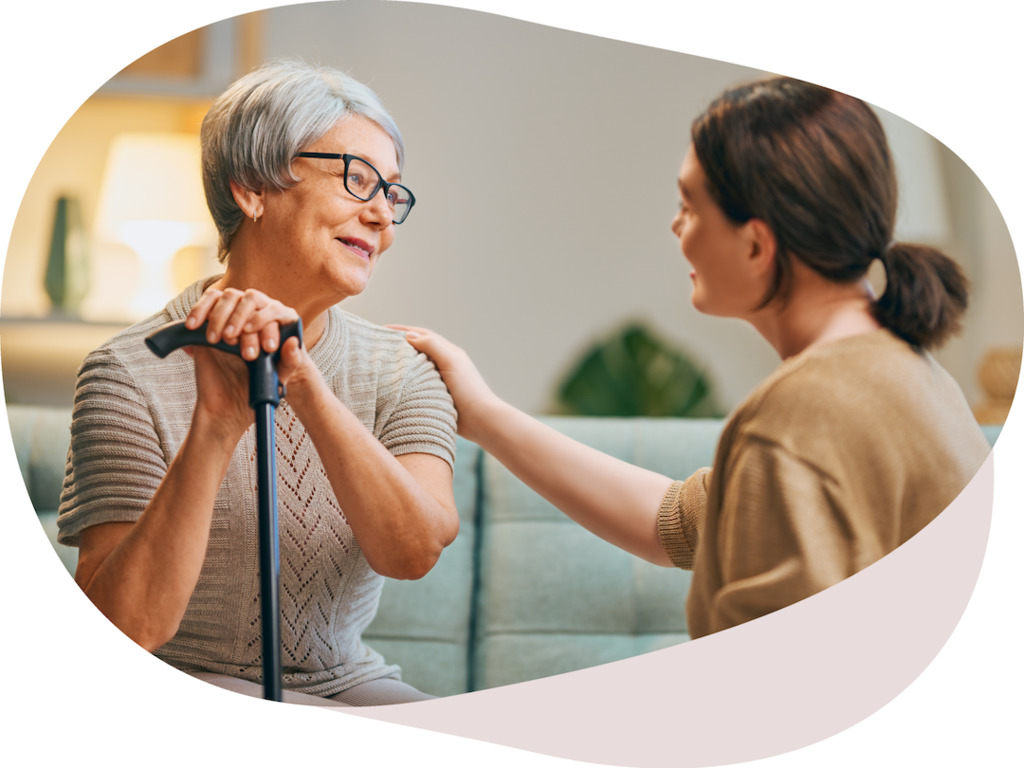 Senior resident and caregiver in conversation