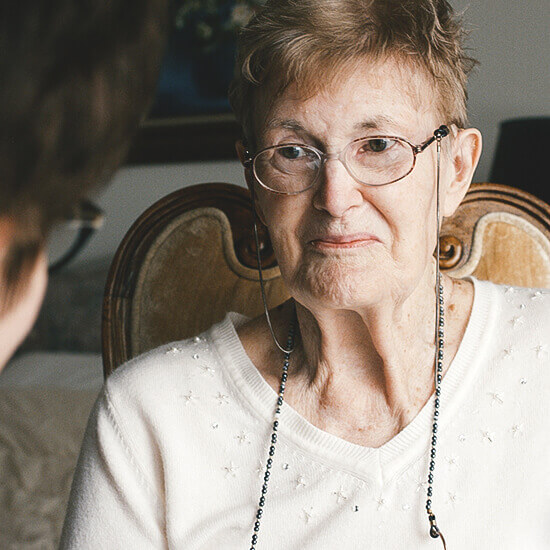 Close-up of a senior woman in a cozy setting.