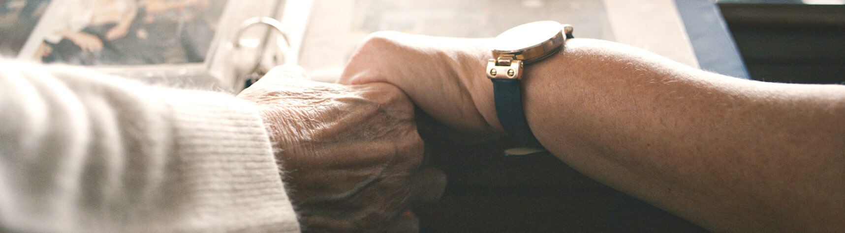 Two hands holding each other warmly.