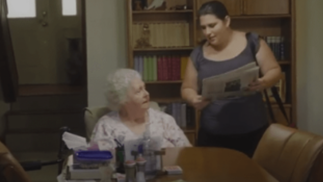 Caregiver interacting with a resident in a common area.