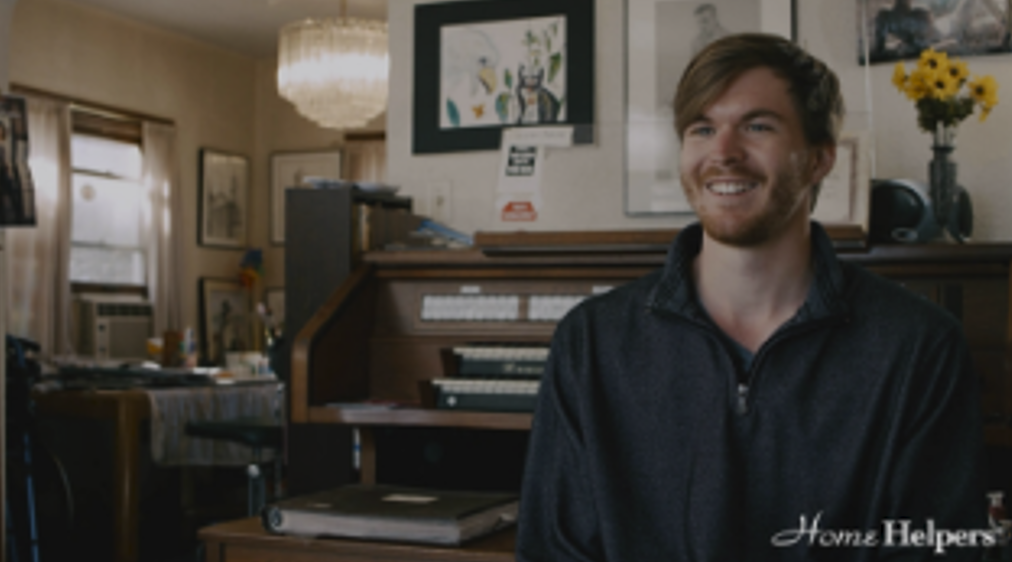 Smiling staff member in a cozy interior setting.