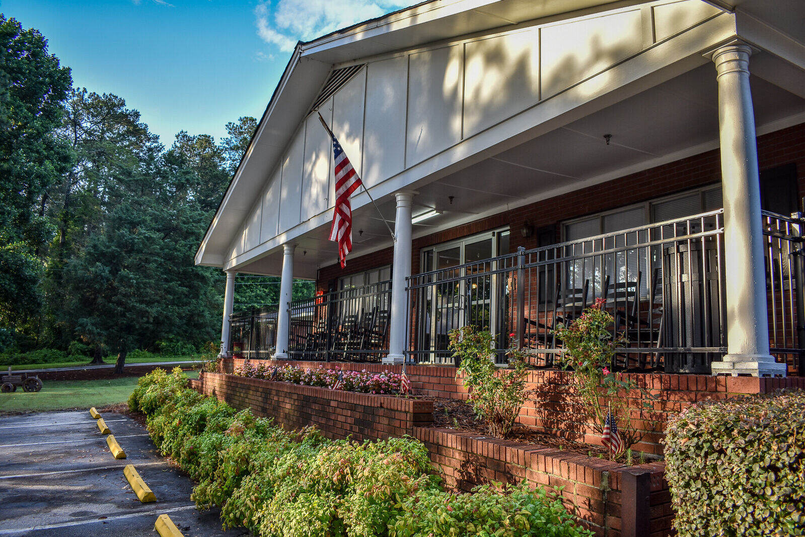 Exterior view of the Winder Center with rocking chairs and flowerbeds