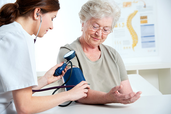 Nurse taking a patient's blood pressure