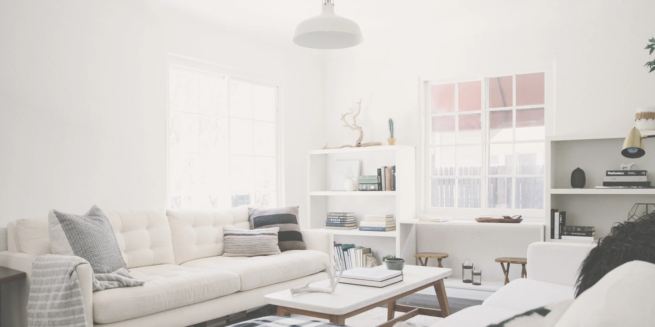 Bright common area with white furniture.