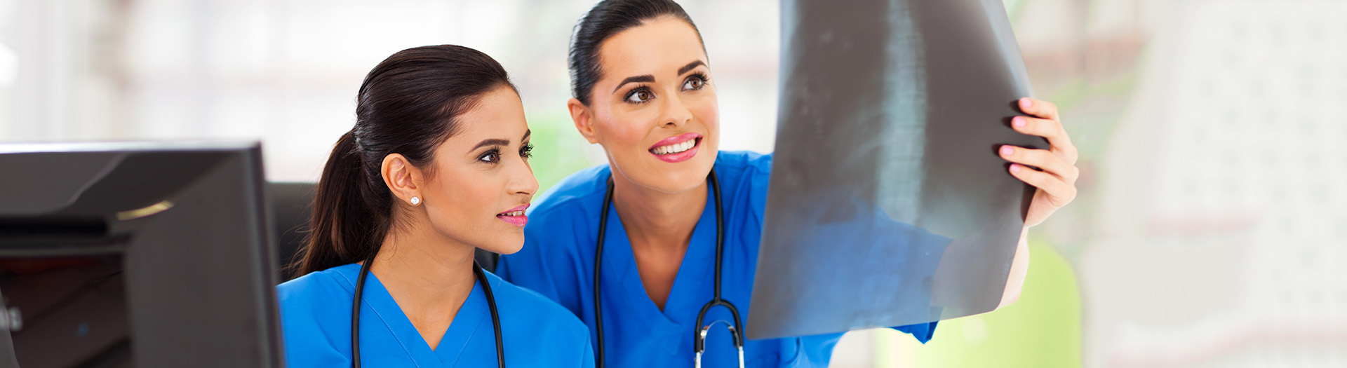 Two healthcare professionals examining an X-ray